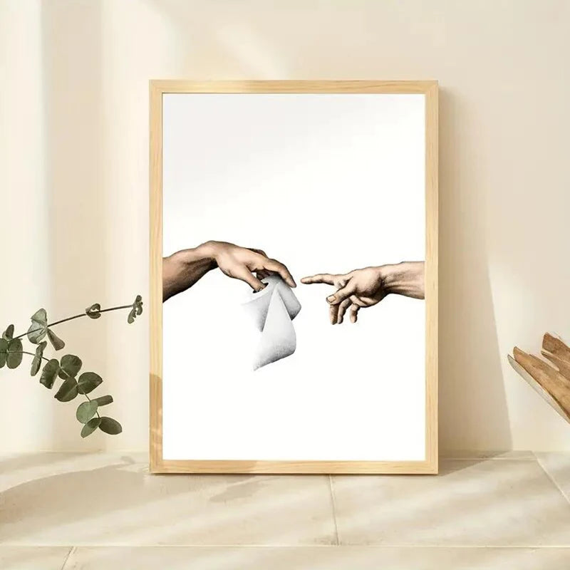 Framed artwork of two hands reaching towards each other on a light background