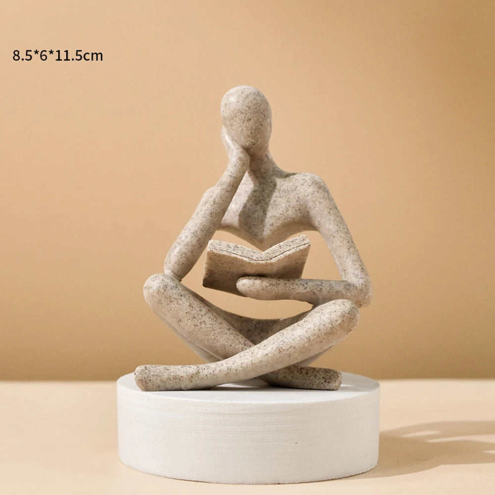 Abstract sculpture of a person on a white base against a beige background