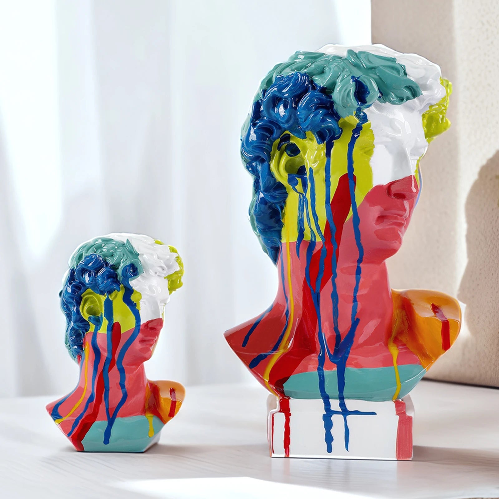 David Colorful abstract sculpture of a face on a white surface with a neutral background