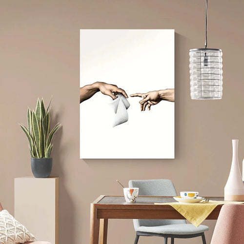 Modern interior with a painting of two hands reaching towards each other, a plant, and a dining table.